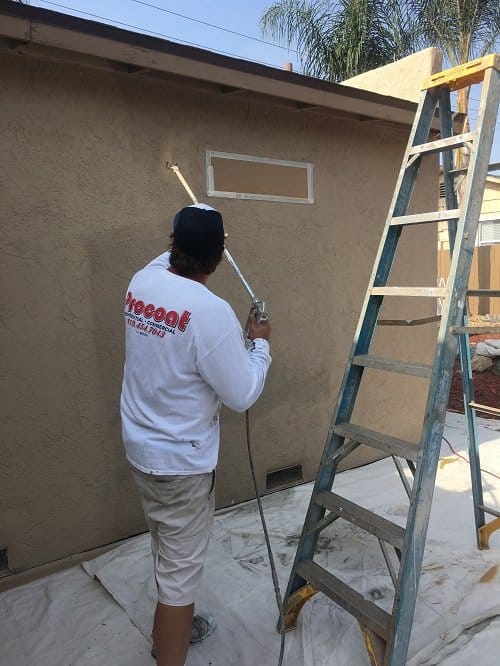 Action Shot of Procoat Painting Spraying an Exterior Painting Project