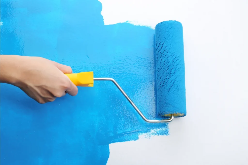 Painter painting wall with roller Procoat Painting San Diego